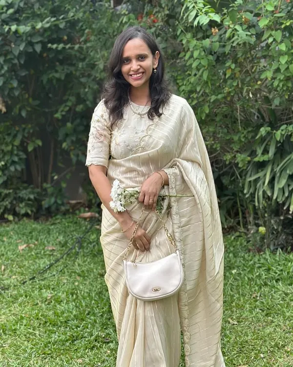 Our client looking absolutely radiant in our fancy tissue saree with pearl scallop work. It's perfect for an elegant, understated look.