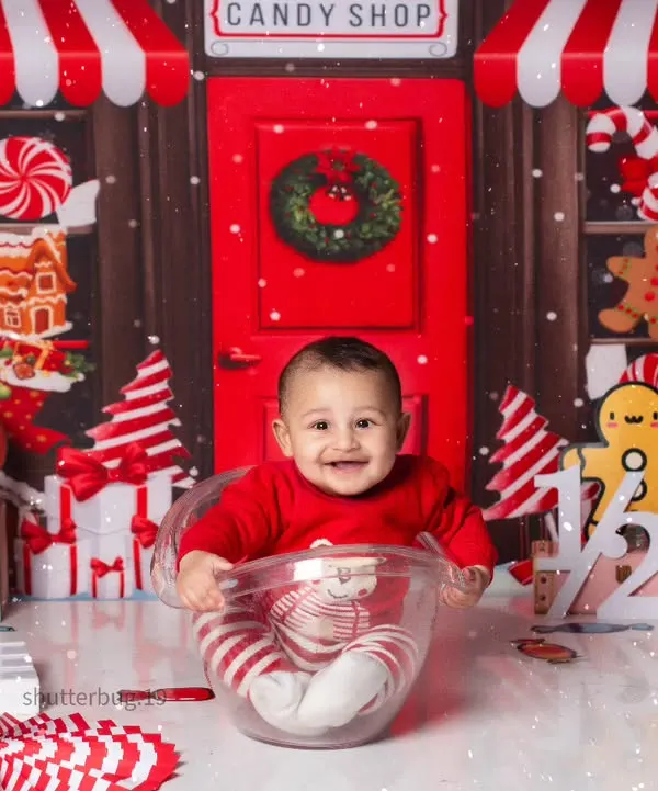 This happy baby is all smiles sitting in a giant teacup in our festive red and white Candy Land theme.