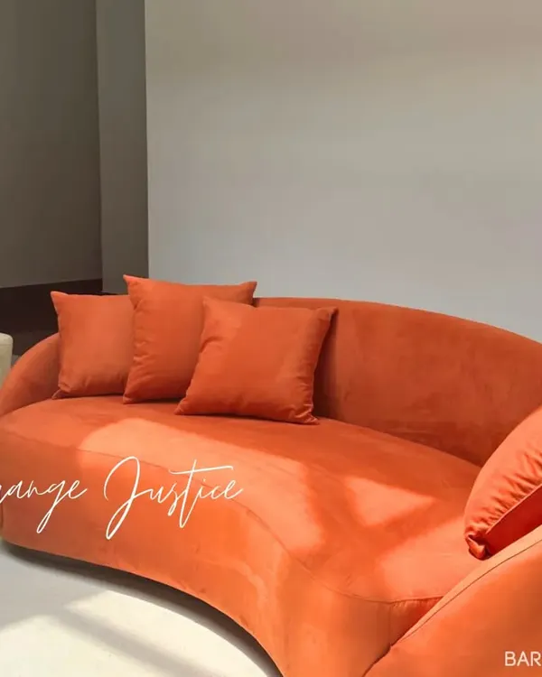 We believe furniture should be fun. This bright orange, curved sofa is a perfect example of how we play with color and form to create pieces that are both comfortable and conversation-starters.