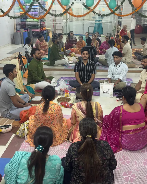 A wide shot of our community gathered for a Hawan ceremony at the yoga center, filling the space with sacred energy.