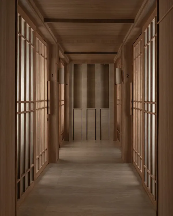 A meditative corridor at the Be Well wellness center, lined with rhythmic, wood-framed screens. The design uses symmetry and a restricted material palette to create a powerful sense of calm and order.
