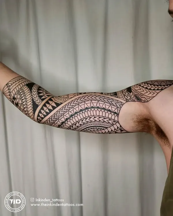 A full freehand Maori sleeve, showcasing intricate patterns and bold lines. Each element is designed to flow with the arm's muscles, creating a cohesive and powerful piece of body armor that tells a personal story.