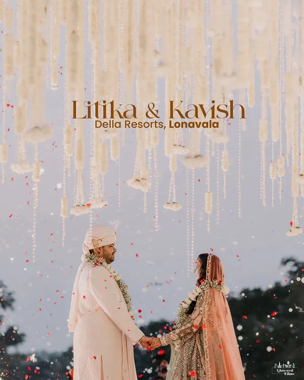 A magical varmala moment for Litika and Kavish at Della Resorts, Lonavala. The mandap, with its cascading floral strings against the open sky, created a truly ethereal setting.