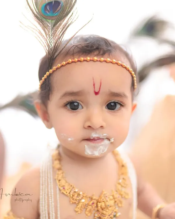 This is the art I love to create. A close-up of a mischievous little Krishna, caught with a mouthful of butter. These thematic baby portraits are more than just pictures; they are stories frozen in time.