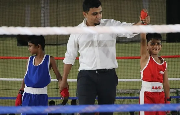 This is what it's all about. A young fighter, hand raised in victory after a controlled, supervised match. We build confidence and discipline in the ring.
