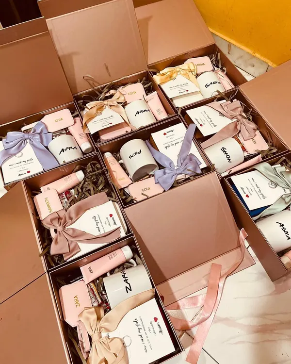 A closer look at our bridesmaid proposal hampers. Each box is personalized with a name and filled with curated items, then tied with a beautiful satin ribbon. We use different colored ribbons to match the bride's theme.