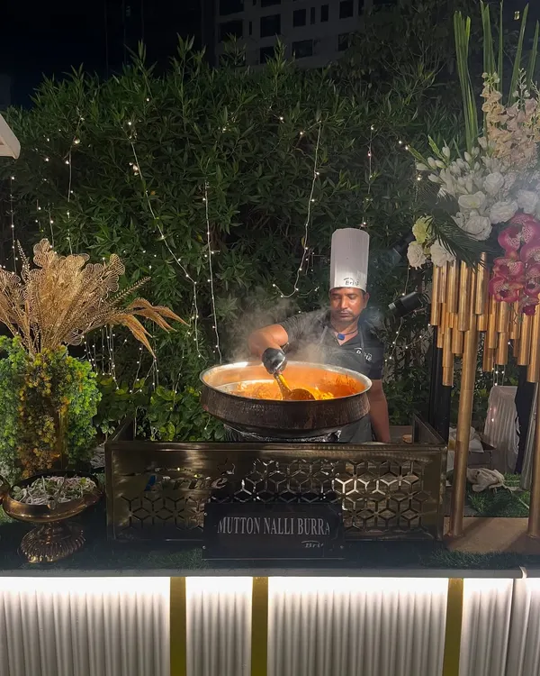 Steam rises from a large karahi as my chef prepares Mutton Nalli Burra. This rich, traditional Mughlai dish is slow-cooked to perfection, ensuring tender meat and a deeply flavorful gravy that is a true highlight of our Indian menu.