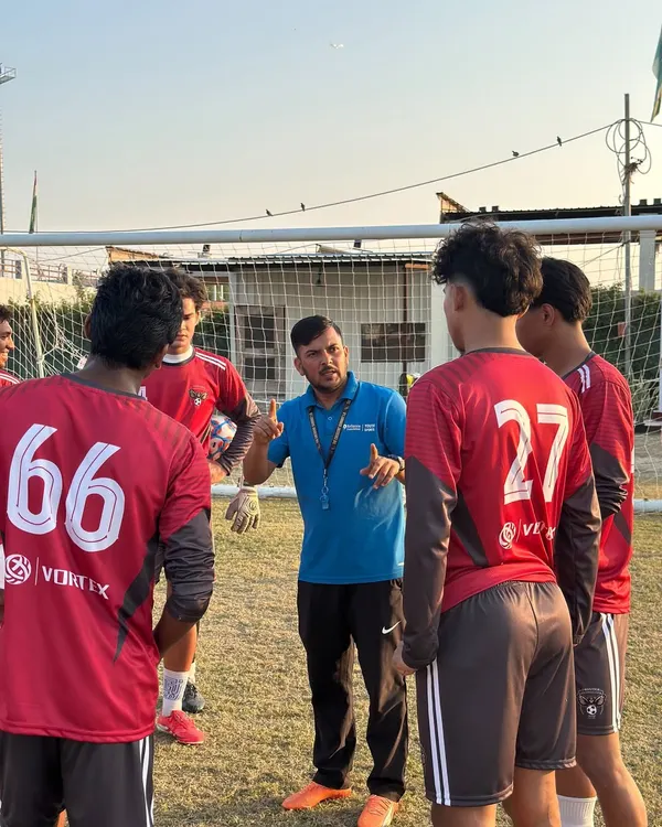 Our coach leading a team talk during a training session. Clear communication and strategy are just as important as physical fitness.
