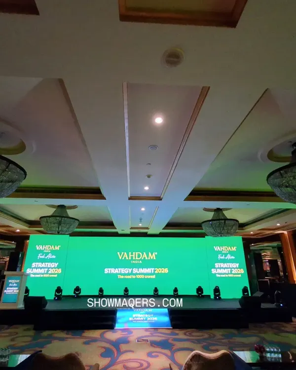 We design and execute high-impact stage setups for corporate summits and conferences. This wide-shot of the Vahdam Strategy Summit shows a seamless, wall-to-wall LED screen, professional lighting, and a clean stage design that ensures the focus remains on the presentation.