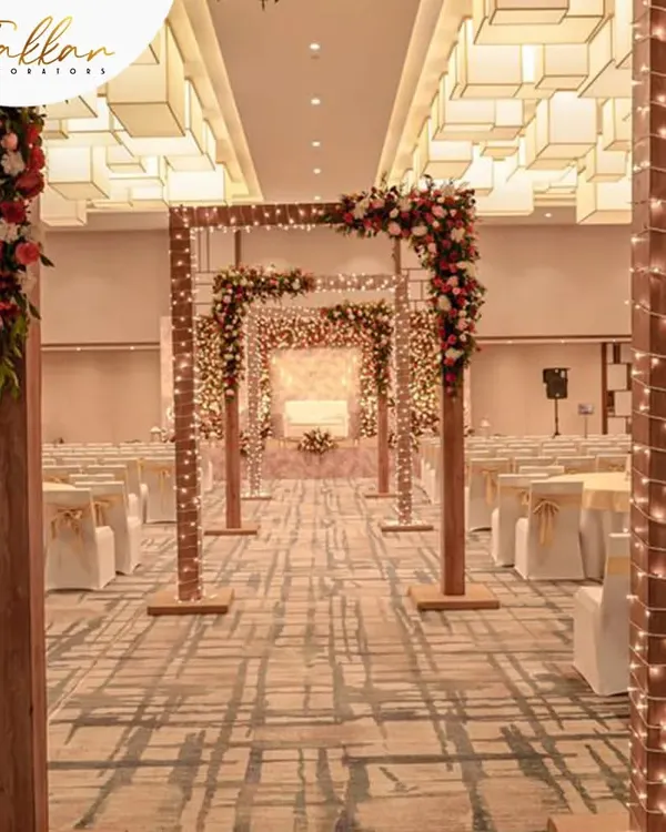 Imagine walking down an aisle like this. I created this indoor wedding aisle with a series of wooden arches wrapped in fairy lights, leading to a beautifully decorated mandap.