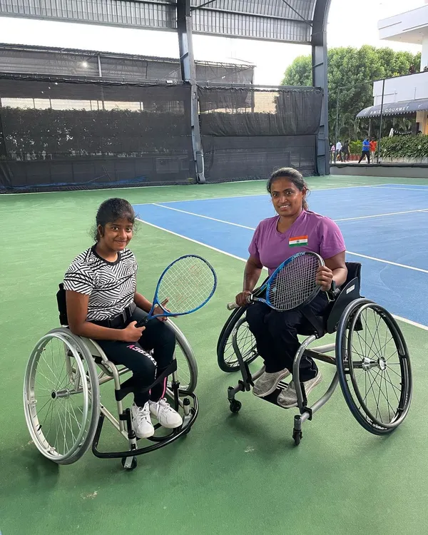 Two of our wheelchair tennis athletes sharing a moment of camaraderie on the court. We believe in creating a supportive environment where players inspire and motivate each other on their journey.