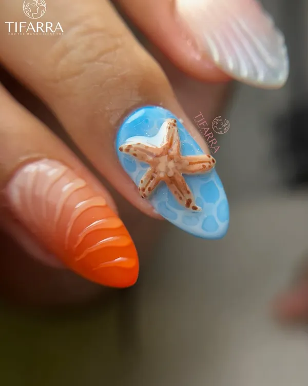 A close-up of a hand-sculpted 3D starfish on a nail with a realistic water pool effect, next to a vibrant orange seashell-textured nail.