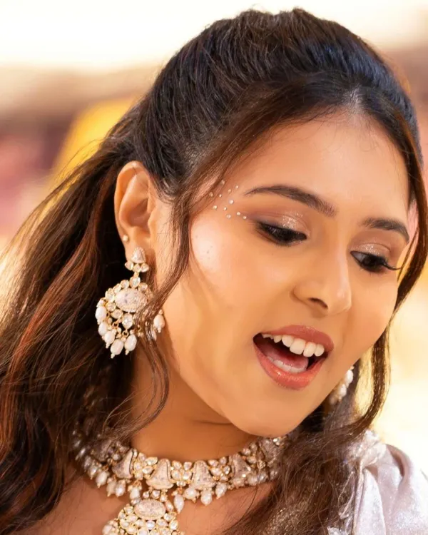 A close-up on the sangeet glam. This shot highlights the shimmering eyeshadow, the subtle wing, and the delicate face gems that add a touch of sparkle and magic to the look.