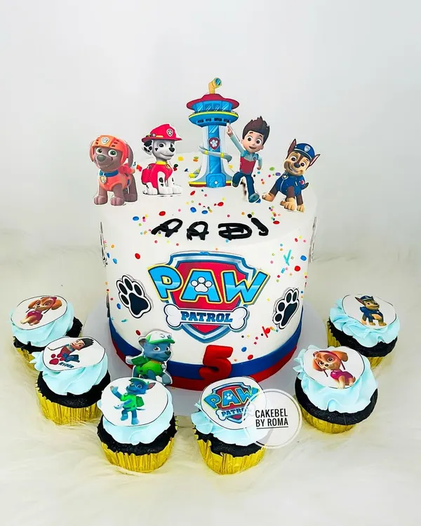 Paw Patrol is on a roll. This birthday cake features the whole team with Ryder, Chase, and Marshall, complete with the iconic Paw Patrol logo and matching character cupcakes.