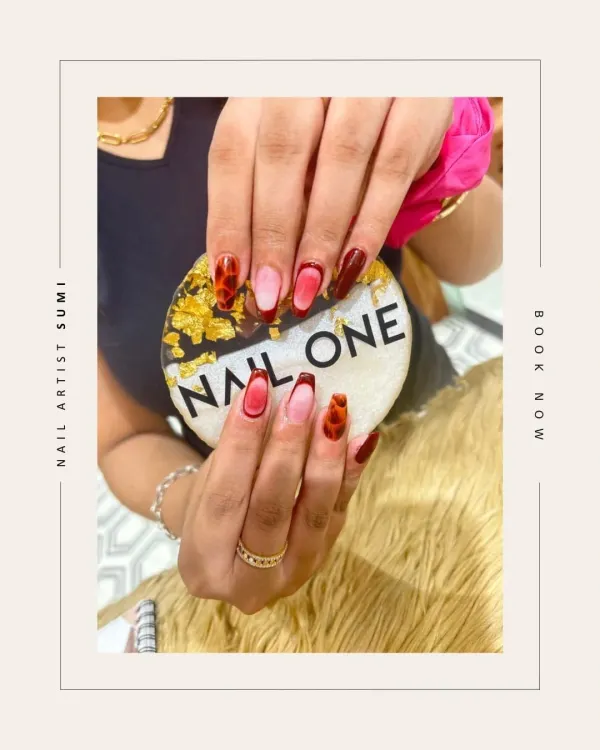 This trendy design by our artist Sumi features a dramatic ombré from nude to deep red, framed with a tortoise shell pattern. It's a bold and fashionable look that combines multiple techniques.