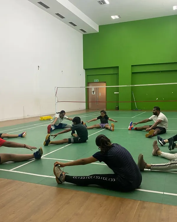 Flexibility prevents injuries and improves reach. Here, a group cools down with post-training stretches, an important part of our daily regimen for recovery and muscle health.