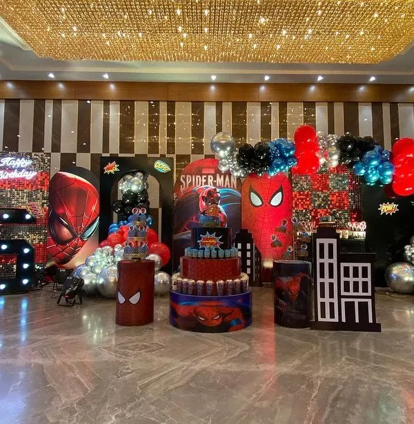 This is how we bring a superhero universe to life. For this grand Spider-Man theme party, I created a complete environment with multiple backdrops, life-sized character cutouts, a themed multi-tier cake display, and dramatic balloon arrangements in signature red, blue, and black.