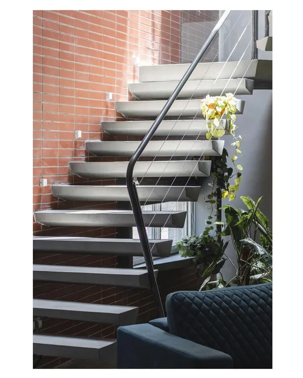 This floating concrete staircase is a signature element, showcasing our love for cantilevered forms. The design is both structurally honest and sculpturally beautiful, appearing to defy gravity.