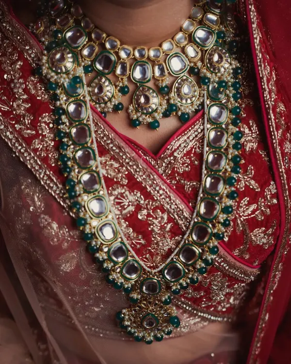 A close-up of a bride's layered kundan necklace. I love capturing these wedding day detail shots that showcase the artistry of Indian bridal jewelry and the texture of the wedding attire.
