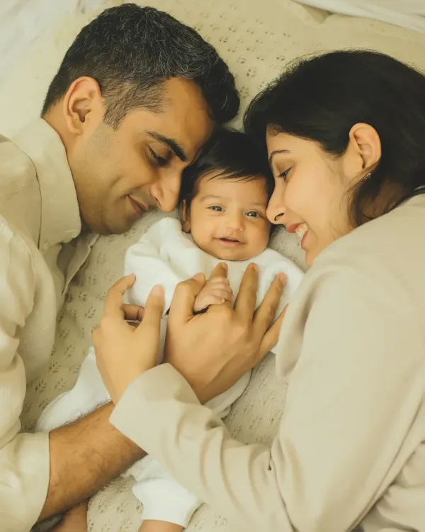 There's nothing sweeter than a baby's first smiles. Capturing this moment of joy between new parents and their little one is what I love to do.