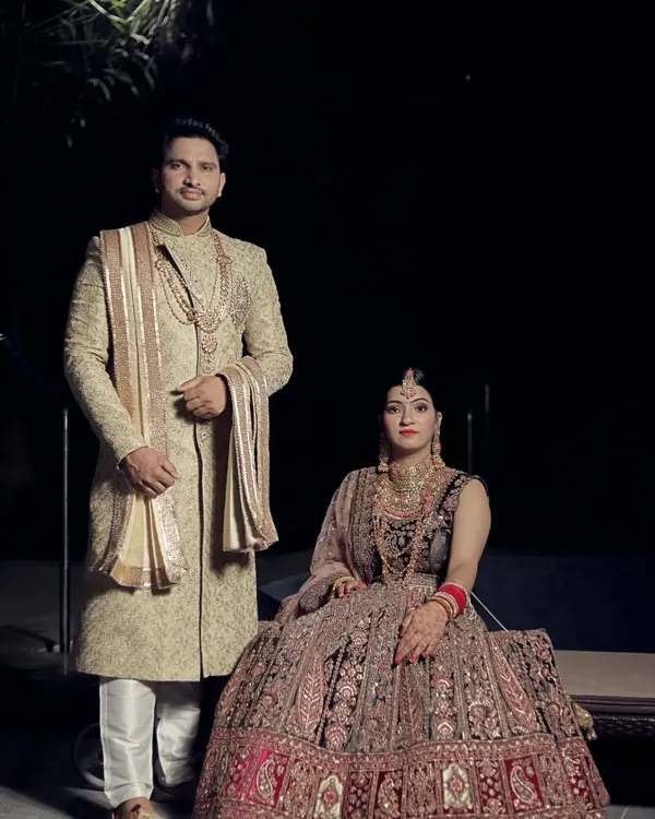 This is the look that turns heads. A perfectly coordinated couple in our premium rental wedding attire, featuring a heavily embroidered bridal lehenga and a regal groom's sherwani. We make sure you both look like royalty on your big day.