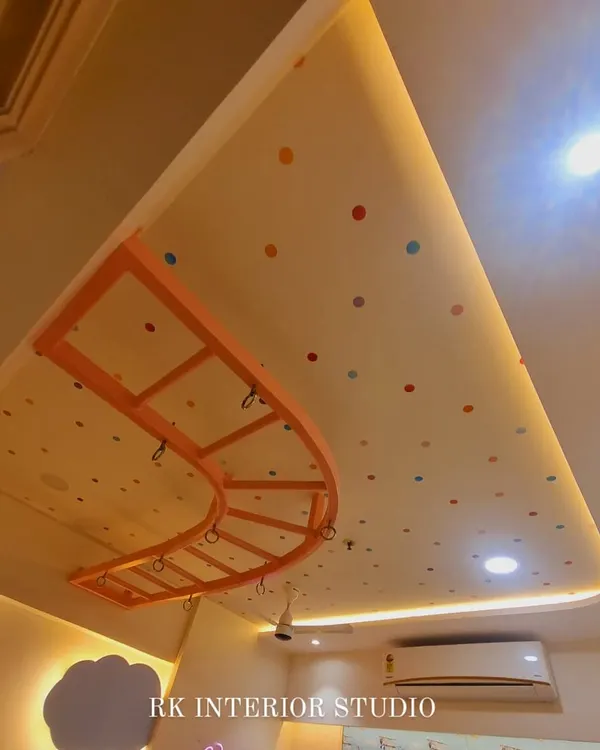 A fun detail from a kids' room ceiling, featuring a polka dot pattern and a custom-made monkey bar for playtime.