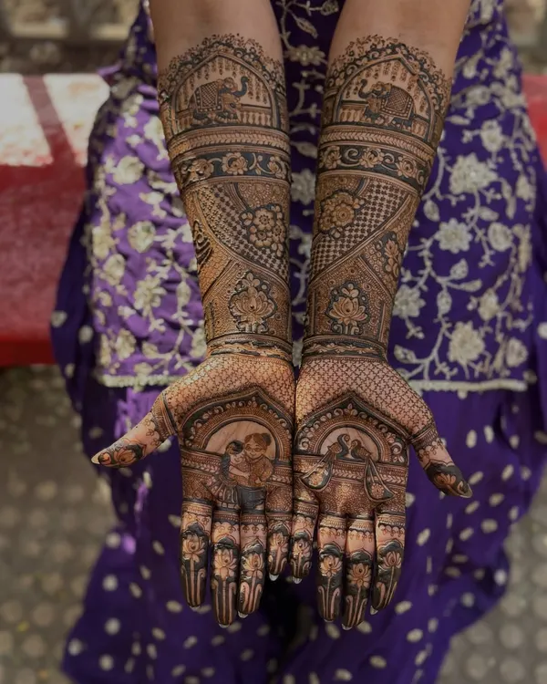 This bride wanted to honor her grandmother, so we placed a beautiful portrait of her aaji right on her palm. It’s such a touching way to include family heritage in your bridal henna.