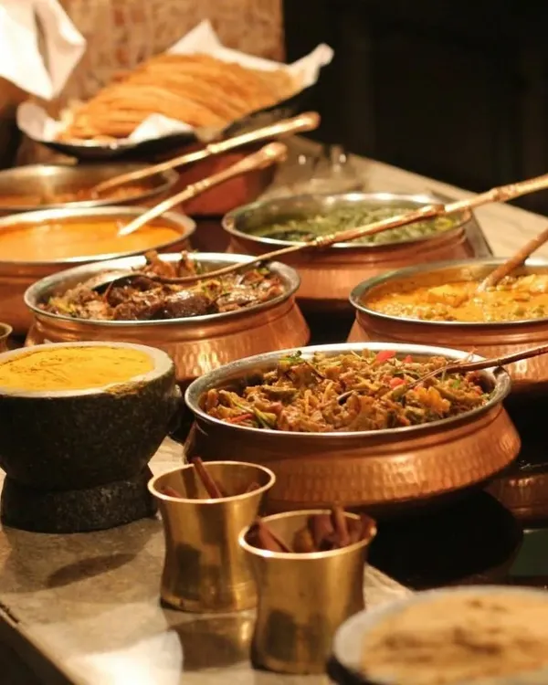 A traditional Indian feast served in authentic copper and stone bowls. This style of presentation is perfect for religious ceremonies and festive events where heritage and authenticity are key.