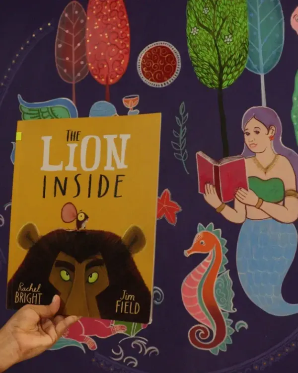 In our 'Sea of Stories' library, we read "The Lion Inside" to a group of children who are deaf and mute. The story was held up against our beautiful underwater mural, creating a truly immersive experience. It was a quiet, moving session that showed how stories can connect us all.