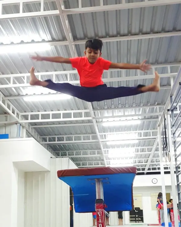 We believe gymnastics is the foundation for all movement, helping build strength, coordination, and confidence that lasts a lifetime. Here, one of our young gymnasts demonstrates a perfect split jump over the vaulting horse.