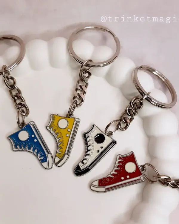 Gifts for the goal-getters. This collection of shoe-themed keychains is perfect for any sneakerhead or sports lover.