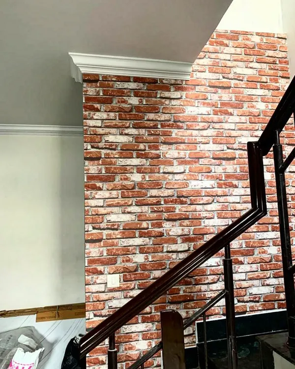 You don't need real bricks to get the classic exposed brick look. This high-quality wallpaper provides a realistic red brick texture, perfect for an industrial or rustic accent wall along a staircase.