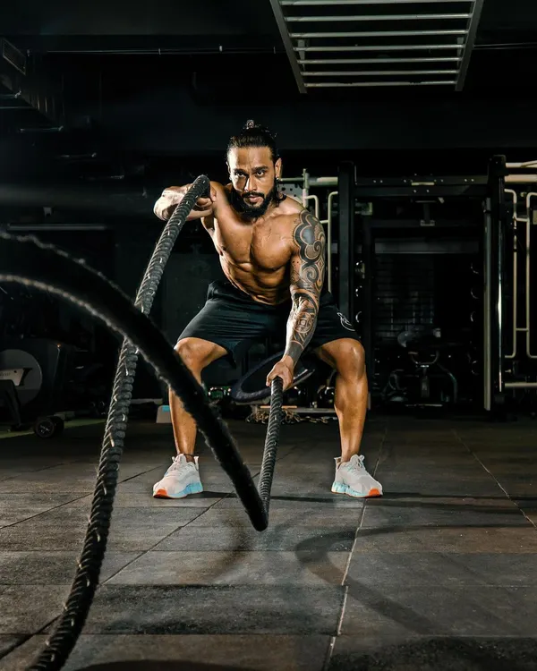 The battle ropes are a fantastic tool for high-intensity interval training (HIIT) and building explosive power. I incorporate functional exercises like this to improve cardiovascular health and muscular endurance.