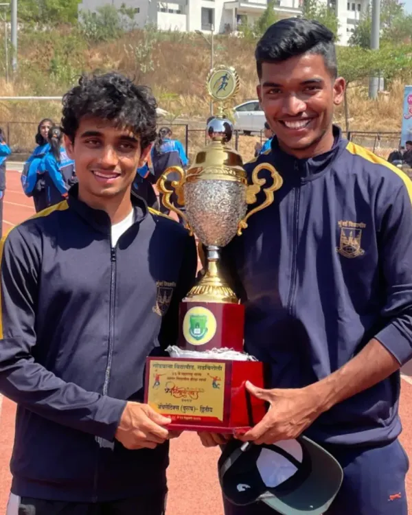 This is what it's all about. Two of my athletes holding the team championship trophy at the Maharashtra State Inter-University Athletics Championship. We train for these moments, where teamwork and individual grit come together for the ultimate win.