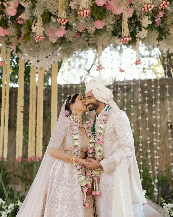A stolen kiss under a canopy of flowers for Sid and Kanika at the Rambagh Palace in Jaipur. A perfect blend of tradition and romance.