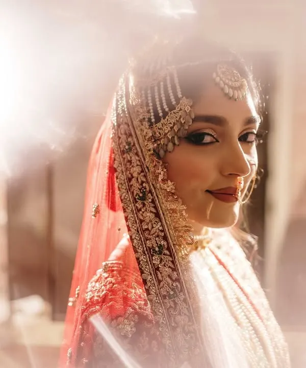 A stunning bridal portrait using creative flare to create a dreamy, ethereal glow. This artistic approach highlights the bride's beauty and the magic of the moment.