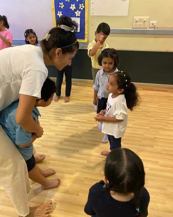 A quiet moment of guidance and connection during a rehearsal. We believe in nurturing our little stars, giving them the individual attention they need to build confidence and understand their role within the larger group.