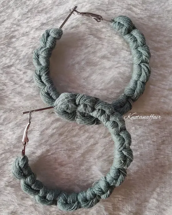 A pair of custom-made macrame hoop earrings in sage green. These were part of a matching set with a hairband for a very special client order.