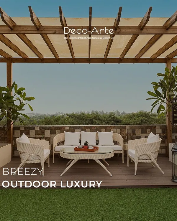 Bask in breezy outdoor luxury on this rooftop terrace. A wooden pergola provides shade over elegant white wicker furniture, creating a serene escape that blends natural comfort with sophisticated design.