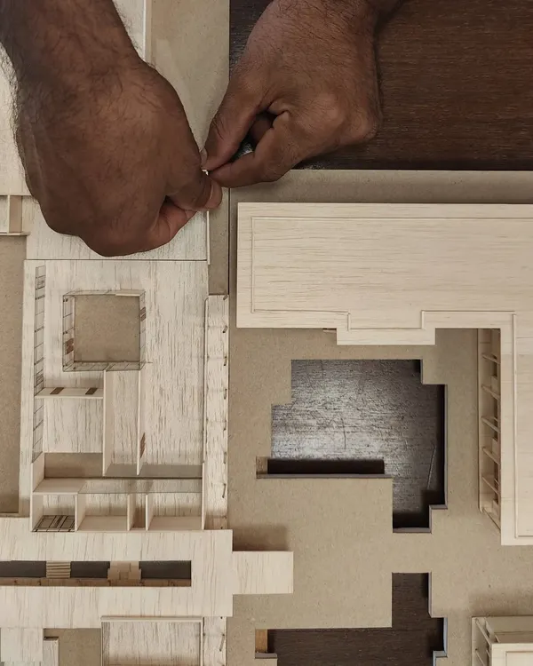 Our master model maker, Vijay, meticulously crafting a detailed model. Physical models are fundamental to our design process, helping us understand scale, light, and spatial relationships in a way that digital tools alone cannot.