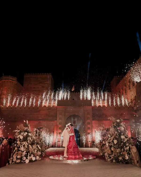 As the night sky over Suryagarh lit up with spectacular fireworks, Shriya and Vedant sealed their love with a magical embrace. This perfect blend of grandeur and romance was a true reflection of their enchanting love story, a moment we were honored to create.
