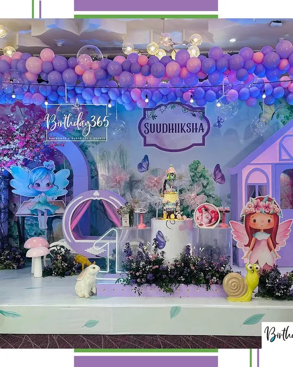 We created an entire enchanted forest for Suudhiksha's fairy-themed birthday. The setup included a custom fairy house, whimsical mushroom props, and a ceiling of purple balloons to make the whole space feel magical.