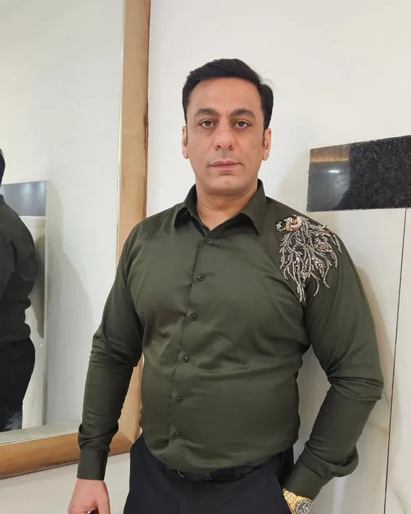The owner, looking sharp in one of his own creations. This olive green shirt with shoulder embroidery is a perfect example of our smart casual wear.