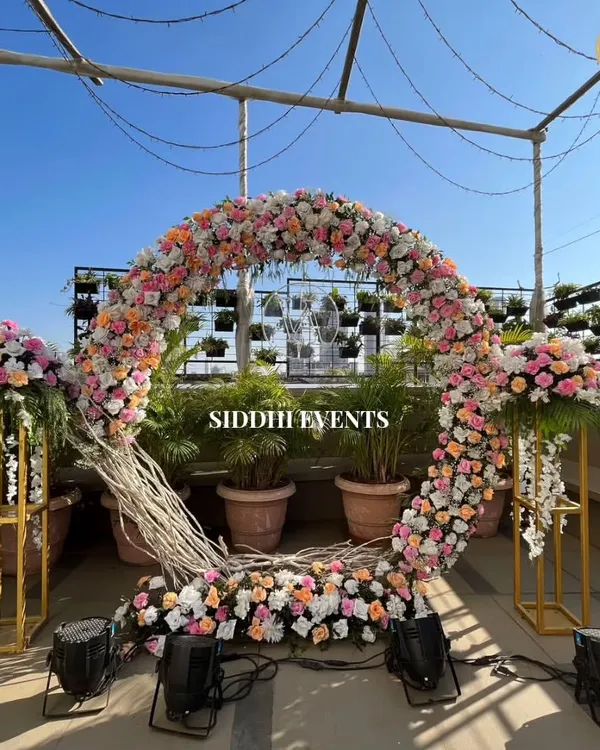 Under an open sky, we crafted this enchanting floral circle, creating a breathtaking rooftop oasis for a truly unforgettable ceremony. This is where love blossoms beneath the sky.