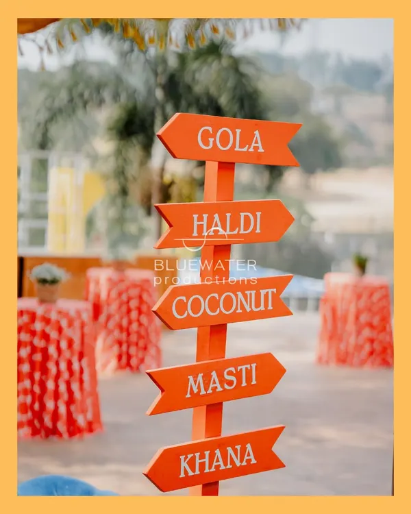 It's all about the fun and masti. We created this quirky directional sign for a Haldi event, pointing guests to all the important stations: Gola, Haldi, Coconut, Masti, and Khana.