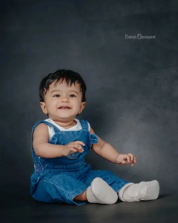Capturing the wonder of new beginnings. A simple denim overall and a happy smile are all you need.