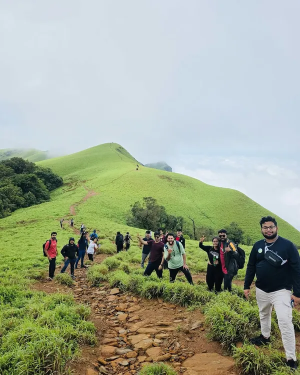 This is what it feels like to be on top of the world with your favorite people. I plan custom treks through the lush green hills of the Western Ghats, creating unforgettable moments like this for your private group.