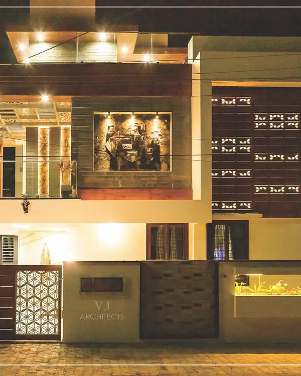 This residence in Hubli, illuminated at night, showcases our approach to modern facade design. We used a combination of wood-finish panels, strategic lighting, and clean geometric forms to create a warm and impressive exterior.
