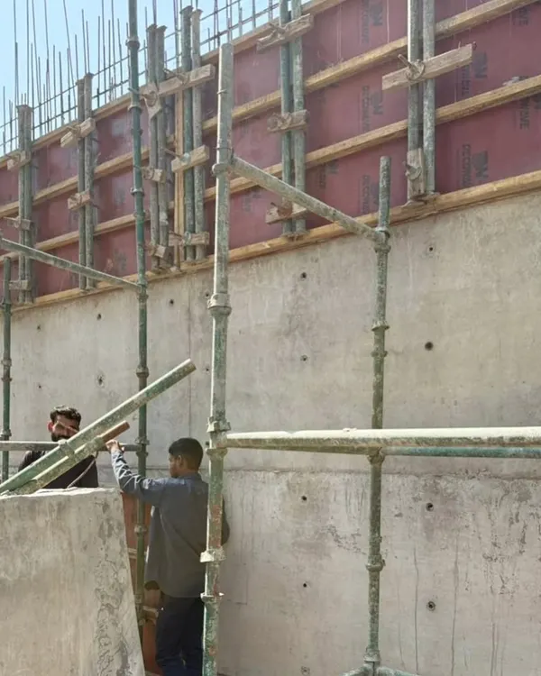 A freshly cast exposed concrete wall at our Himachal site. The formwork has just been removed, revealing the texture and tie-holes that become part of the final architectural finish.
