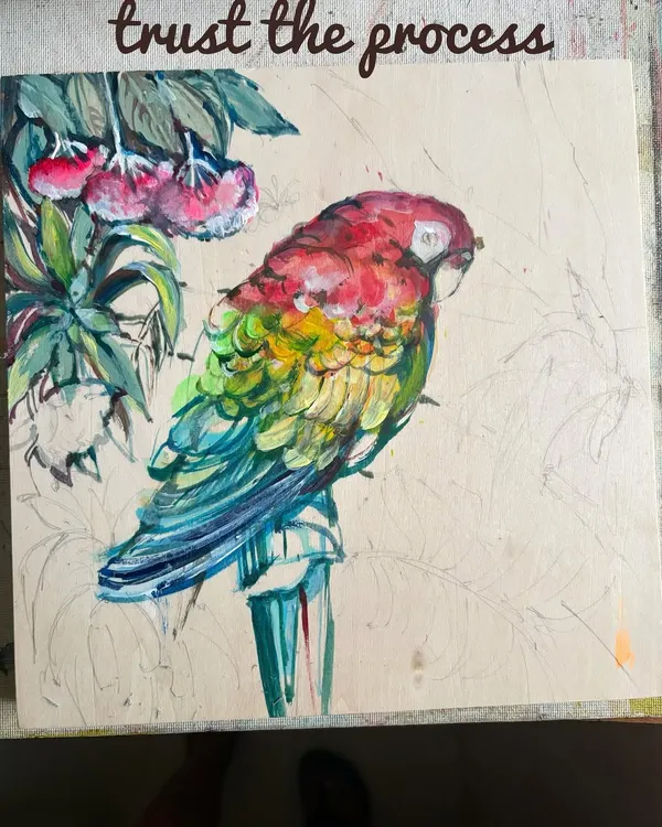 Trust the process. This is a work-in-progress shot of my acrylic macaw painting on wood, showing the layers of color being built up to create the vibrant feathers.